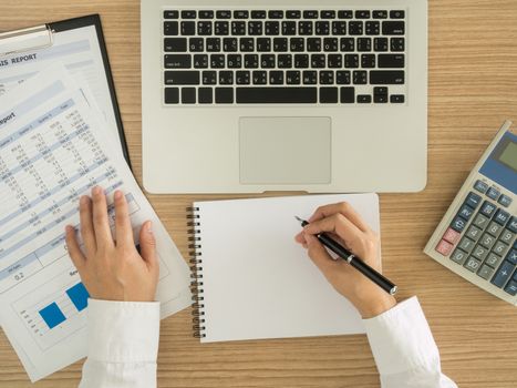 Accountants are analyzing data from the financial statements of the Company. above view.