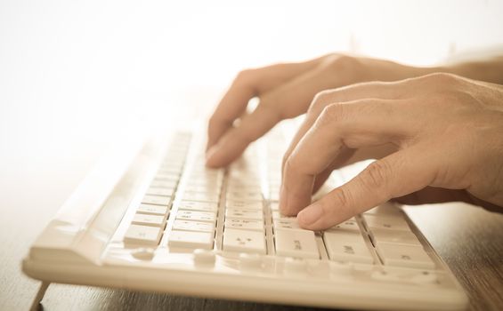 human's hands typing on computer keyboard. selective focus.