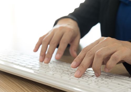 businesswoman using a computer keyboard at office