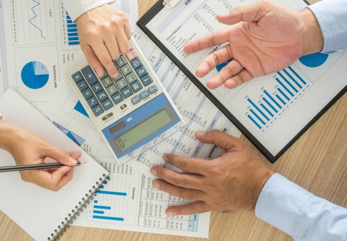 Businessmen are analyzing the data to business planning. top view.