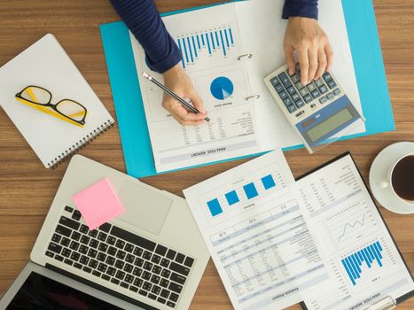 Accountants are working to analyze company data. top view