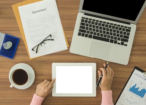 woman working at office desk and using tablet computer.  free space for text.