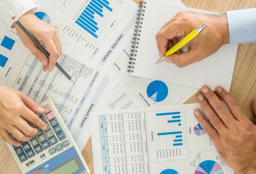 marketer worker analyzing statistical data on desk in office. top view