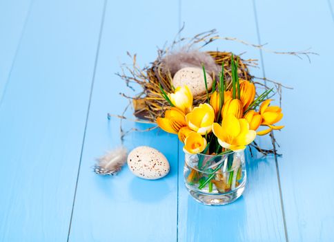 table decoration with easter eggs, on blue wooden background