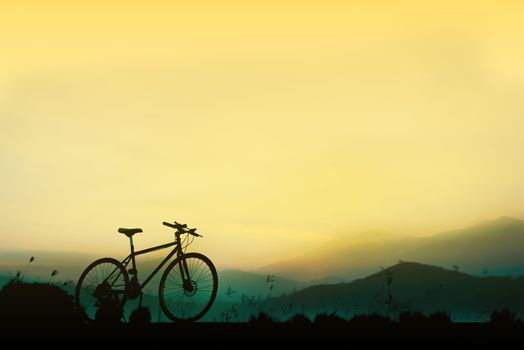 Sunset silhouette and bicycle on beautiful sky