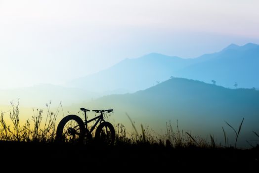 beautiful sunset sky and mountain bike silhouette , silhouette fat bike