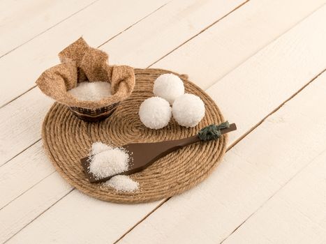 Bath bombs and mineral bath salts on rustic white plank boards