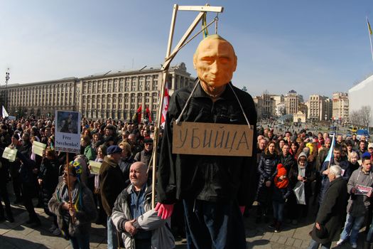 UKRAINE, Kiev: A man holds scaffold with a mannequin of Russian President Vladimir Putin hanging on during a rally to claim Nadiya Savchenko's release in Kiev on March 6, 2016. About thousand people gather in the Independence square downtown Kiev to voice the support for Nadiya Savchenko - “Aydar” Ukrainian volunteer battalion soldier, who is illegally held in Russian captivity after being kidnapped. Savchenko went on a dry hunger strike on March 4, 2016, after being over 75 days of hunger strike.