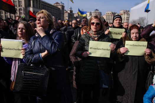 UKRAINE, Kiev: People hold placards whith a portrait of Nadiya Savchenko and inscription #FreeSavchenko during a rally to claim Nadiya Savchenko's release in Kiev on March 6, 2016. About thousand people gather in the Independence square downtown Kiev to voice the support for Nadiya Savchenko - “Aydar” Ukrainian volunteer battalion soldier, who is illegally held in Russian captivity after being kidnapped. Savchenko went on a dry hunger strike on March 4, 2016, after being over 75 days of hunger strike.