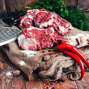 Chopped pieces of raw beef in hot spices on burlap