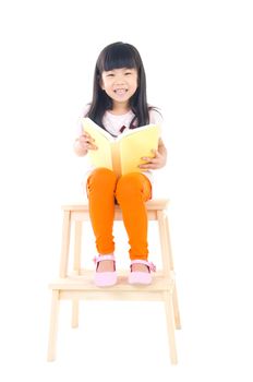 Cute asian girl reading a book