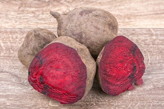 The red beets on a brown wooden background