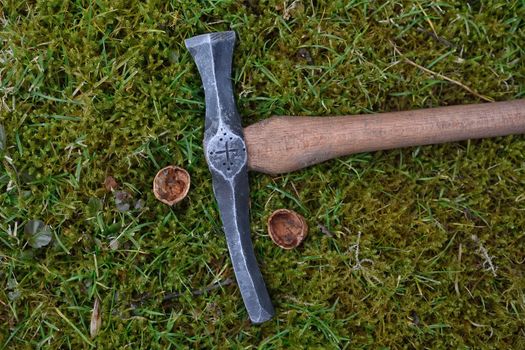 Hand made blacksmith hammer lying on the grass