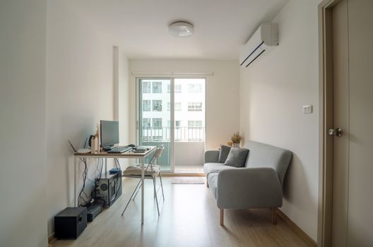 Living room with working area in modern apartment