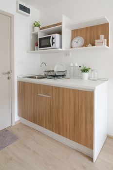 Modern pantry with utensil and sink in apartment