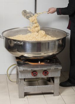 chef cooking rice at a commercial kitchen