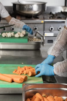 chef preparing food and cutting mushrooms in a restaurant kitchen