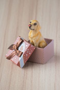 Dog in a gift box on a wooden floor. holiday background. gift background