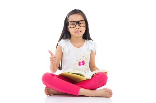 Asian girl wearing spectacles sitting on the floor with books