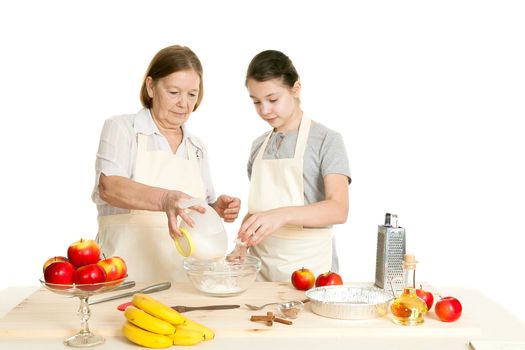 the grandmother and the granddaughter add ingredients to a plate