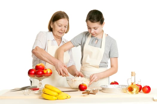 the grandmother and the granddaughter mix ingredients in a plate
