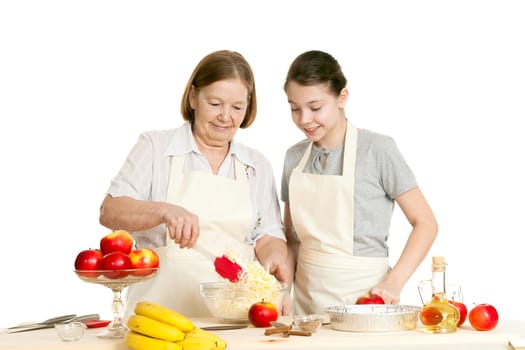 the grandmother and the granddaughter mix ingredients in a plate
