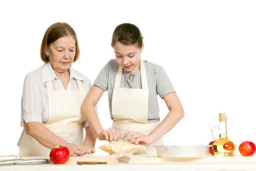 the grandmother and the granddaughter knead dough on a kitchen table