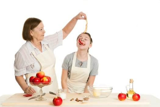 the grandmother treats the granddaughter with a peel from apple