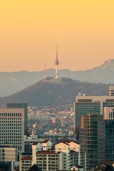 View of Seoul tower and cityscape with golden light in Seoul, South Korea.