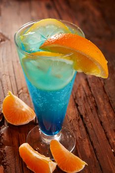 Fresh cocktail with blue curacao on wooden table