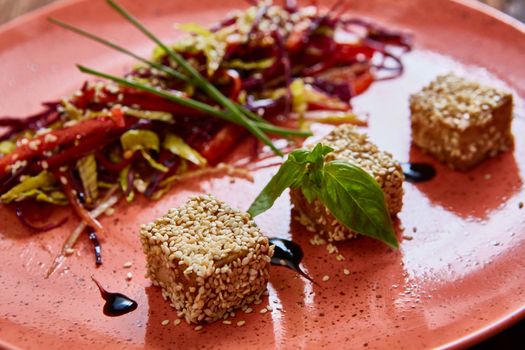 Stir fried tofu in a bowl with sesame and greens