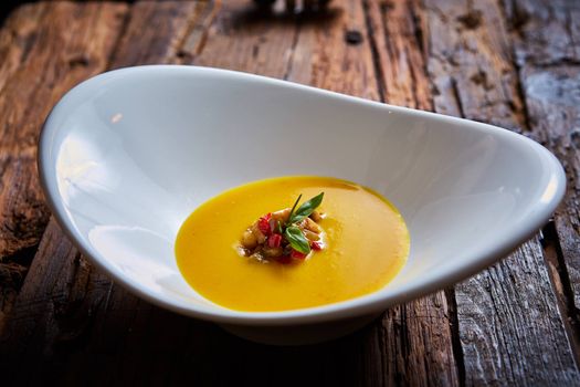 Delicious cream soup made of lentil and vegetables on table, close-up