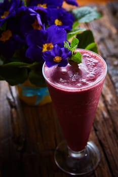 Delicious berry smoothie on table. The close-up