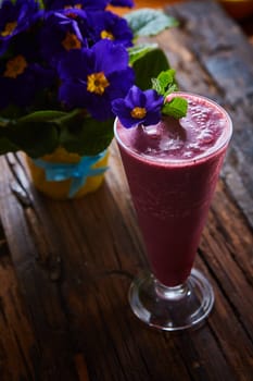 Delicious berry smoothie on table. The close-up