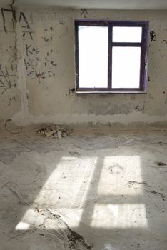 Abandoned empty room with window and light from it