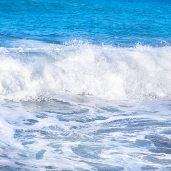 Big wave with sea foam and blue water