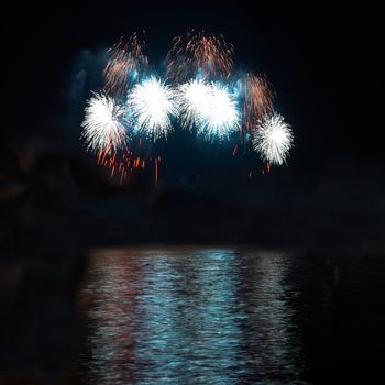 Red colorful holiday fireworks on the black sky background.