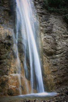 Beautiful waterfall in the forest. Water motion.