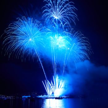 Blue colorful fireworks on the black sky background