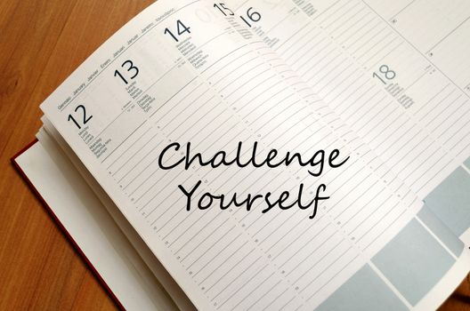 Challenge yourself text concept write on notebook