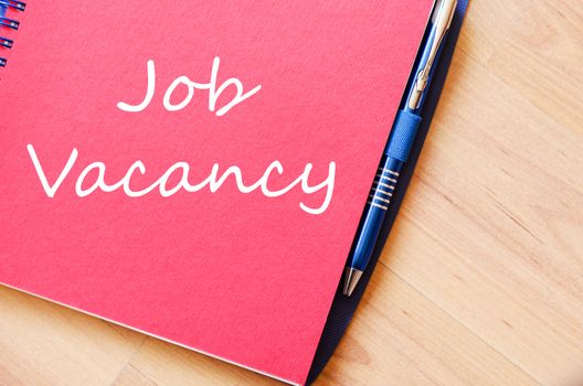 Job vacancy text concept write on notebook with pen