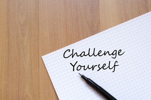 Challenge yourself text concept write on notebook with pen