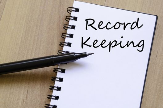 Record keeping text concept write on notebook with pen