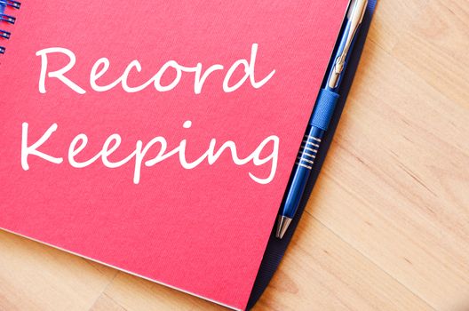 Record keeping text concept write on notebook with pen