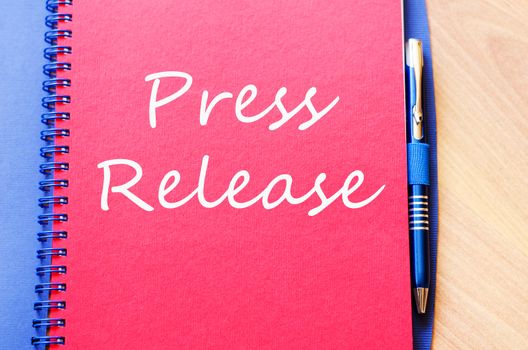 Press release text concept write on notebook with pen