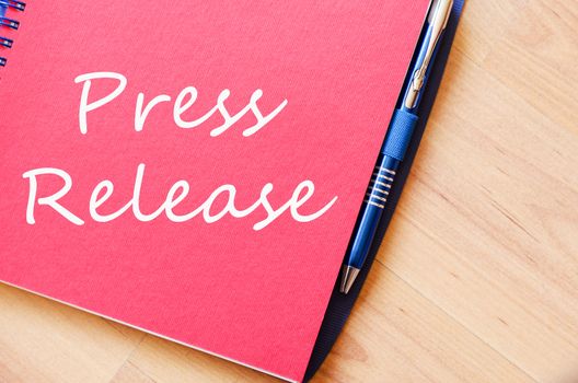 Press release text concept write on notebook with pen