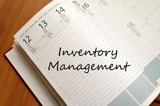 Inventory management text concept write on notebook