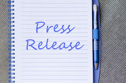 Press release text concept write on notebook with pen