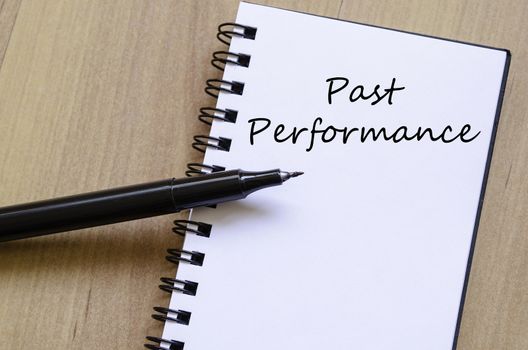Past performance text concept write on notebook with pen