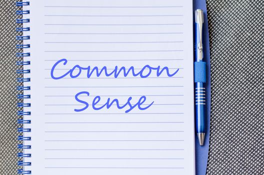Common sense text concept write on notebook with pen